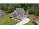 Aerial view showcasing the home, manicured lawn, and proximity to a tranquil pond at 783 Phil Haven Ln, Kennesaw, GA 30152