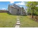 Expansive backyard showcasing a well-maintained lawn, stepping stone path, and multi-level deck on house at 783 Phil Haven Ln, Kennesaw, GA 30152