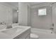Bathroom with a large vanity, granite countertop, and a shower/tub combo with gray tile at 783 Phil Haven Ln, Kennesaw, GA 30152