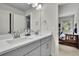 Modern bathroom boasts a double vanity with quartz countertops, framed mirror, and gray cabinetry at 783 Phil Haven Ln, Kennesaw, GA 30152
