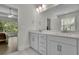 Bathroom featuring a double vanity with white cabinets and granite countertop and natural light at 783 Phil Haven Ln, Kennesaw, GA 30152