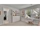 Bright bedroom featuring built-in shelving, a window desk, and neutral carpeting for a cozy, functional space at 783 Phil Haven Ln, Kennesaw, GA 30152