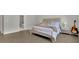 Bright bedroom with a queen bed, nightstand, and an acoustic guitar by the nightstand at 783 Phil Haven Ln, Kennesaw, GA 30152