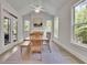 Charming dining area features a fireplace, large windows offering natural light, and a wood table with chairs at 783 Phil Haven Ln, Kennesaw, GA 30152