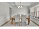 Elegant dining room with coffered ceiling, stylish chandelier, and natural light at 783 Phil Haven Ln, Kennesaw, GA 30152