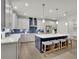 Contemporary kitchen featuring a spacious island with bar stools, white cabinets and stainless steel appliances at 783 Phil Haven Ln, Kennesaw, GA 30152