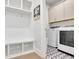 Functional laundry room with built-in storage, a bench, hooks, and a washer/dryer at 783 Phil Haven Ln, Kennesaw, GA 30152