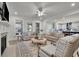 Spacious living room with a fireplace, ceiling fan and neutral-toned furniture offers a relaxing space at 783 Phil Haven Ln, Kennesaw, GA 30152