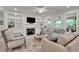 Bright living room features built-in bookshelves, a fireplace, a ceiling fan, and neutral furniture at 783 Phil Haven Ln, Kennesaw, GA 30152