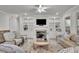 Comfortable living room with a fireplace, TV, built-in shelves and neutral decor offers ample living space at 783 Phil Haven Ln, Kennesaw, GA 30152