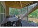 Cozy patio with wooden table and chairs, stone flooring, plus stairs leading up to deck, overlooking wooded area at 783 Phil Haven Ln, Kennesaw, GA 30152