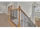 Staircase featuring wood railing and black wrought iron spindles leading to the front door at 783 Phil Haven Ln, Kennesaw, GA 30152