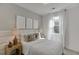 Well-lit bedroom with a bed, nightstands, decorative art, and a window at 1726 Gunnin Nw Trce # 231, Atlanta, GA 30318