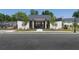 Community entrance features landscaping, a gated entrance, and sidewalks at 1726 Gunnin Nw Trce # 231, Atlanta, GA 30318