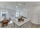 Open concept living space with kitchen island, dining area, and living room with ample natural light at 1726 Gunnin Nw Trce # 231, Atlanta, GA 30318