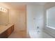 Well-lit bathroom featuring a single sink vanity, full-size mirror, and a tub and shower combination at 2374 Brandenberry Ct, Decatur, GA 30034