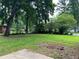 Expansive backyard featuring lush greenery, mature trees, and ample space for outdoor activities and gardening at 4925 Sugar Valley Sw Rd, Mableton, GA 30126