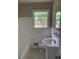 Bright bathroom featuring white tiles, a vanity, and updated fixtures at 4925 Sugar Valley Sw Rd, Mableton, GA 30126