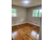 Cozy bedroom with hardwood floors, natural light, and two windows at 4925 Sugar Valley Sw Rd, Mableton, GA 30126