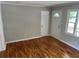 Cozy living room with hardwood floors and natural light from two windows at 4925 Sugar Valley Sw Rd, Mableton, GA 30126