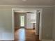 Inviting living room with hardwood floors and an open doorway to kitchen at 4925 Sugar Valley Sw Rd, Mableton, GA 30126
