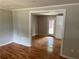 Inviting living room with hardwood floors and an open doorway at 4925 Sugar Valley Sw Rd, Mableton, GA 30126