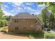 Spacious backyard with mature trees and a home with two stories at 7615 Abbey Glen Dr, Cumming, GA 30028
