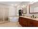 Relaxing bathroom with double vanity, soaking tub, and separate shower at 7615 Abbey Glen Dr, Cumming, GA 30028