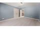Light blue bedroom featuring neutral carpeting and double closets at 7615 Abbey Glen Dr, Cumming, GA 30028