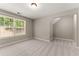 Neutral bedroom with a large window that provides plenty of natural light at 7615 Abbey Glen Dr, Cumming, GA 30028