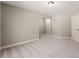 Spacious bedroom with neutral carpeting and a walk-in closet at 7615 Abbey Glen Dr, Cumming, GA 30028