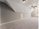 A spacious bonus room features carpeted floors and angled ceilings at 7615 Abbey Glen Dr, Cumming, GA 30028