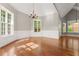 Elegant dining room with wainscoting, hardwood floors, and large windows at 7615 Abbey Glen Dr, Cumming, GA 30028