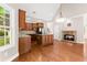 Stylish kitchen featuring stainless steel appliances, hardwood floors, and stone fireplace at 7615 Abbey Glen Dr, Cumming, GA 30028