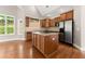 Well-lit kitchen with stainless steel appliances, island, and ample cabinet space at 7615 Abbey Glen Dr, Cumming, GA 30028