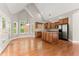 Open concept kitchen with stainless steel appliances, island, and adjacent dining area at 7615 Abbey Glen Dr, Cumming, GA 30028