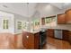 Spacious kitchen features an island, stainless steel appliances, and hardwood flooring at 7615 Abbey Glen Dr, Cumming, GA 30028