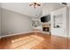 Bright living area with stone fireplace, vaulted ceilings, and gleaming hardwood floors at 7615 Abbey Glen Dr, Cumming, GA 30028