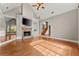 Spacious living room with hardwood floors, stone fireplace, and vaulted ceilings at 7615 Abbey Glen Dr, Cumming, GA 30028
