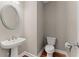 Cozy powder room features modern fixtures and a decorative mirror at 7615 Abbey Glen Dr, Cumming, GA 30028