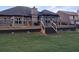 Spacious wooden deck with stairs leading to the backyard and a covered gazebo at 1128 Carillon Dr, Conyers, GA 30013