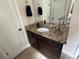 A bathroom featuring a dark vanity with granite countertops and tile flooring at 1128 Carillon Dr, Conyers, GA 30013