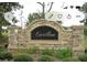 Stone entrance sign for Carillon subdivision with mature landscaping at 1128 Carillon Dr, Conyers, GA 30013