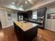 A beautiful kitchen with a large island, granite countertops, stainless steel appliances, and dark wood cabinets at 1128 Carillon Dr, Conyers, GA 30013