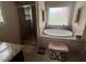 Bathroom featuring a shower, a separate soaking tub, and tile flooring at 1128 Carillon Dr, Conyers, GA 30013