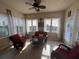 Cozy sunroom with a ceiling fan, tile flooring, and lots of natural light at 1128 Carillon Dr, Conyers, GA 30013