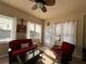 Bright sunroom with comfortable seating, ceiling fan, and sun-drenched tile floor at 1128 Carillon Dr, Conyers, GA 30013