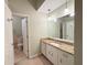 Bathroom featuring a granite vanity top, cabinets, large mirror, and updated lighting at 2872 Bentwood Dr, Marietta, GA 30062