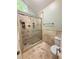 Beautiful bathroom featuring travertine tile and a glass shower at 2872 Bentwood Dr, Marietta, GA 30062