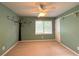Cozy carpeted bedroom with a ceiling fan, and natural light from a window with backyard views at 2872 Bentwood Dr, Marietta, GA 30062